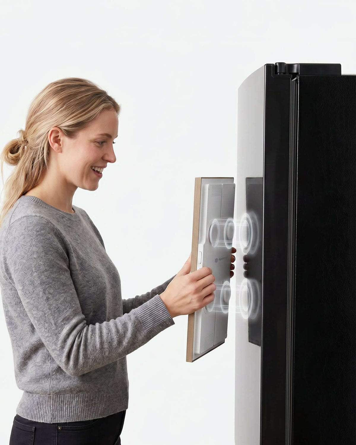 Woman attaching Apolosign Digital Calendar Magnetic Mount to a refrigerator.