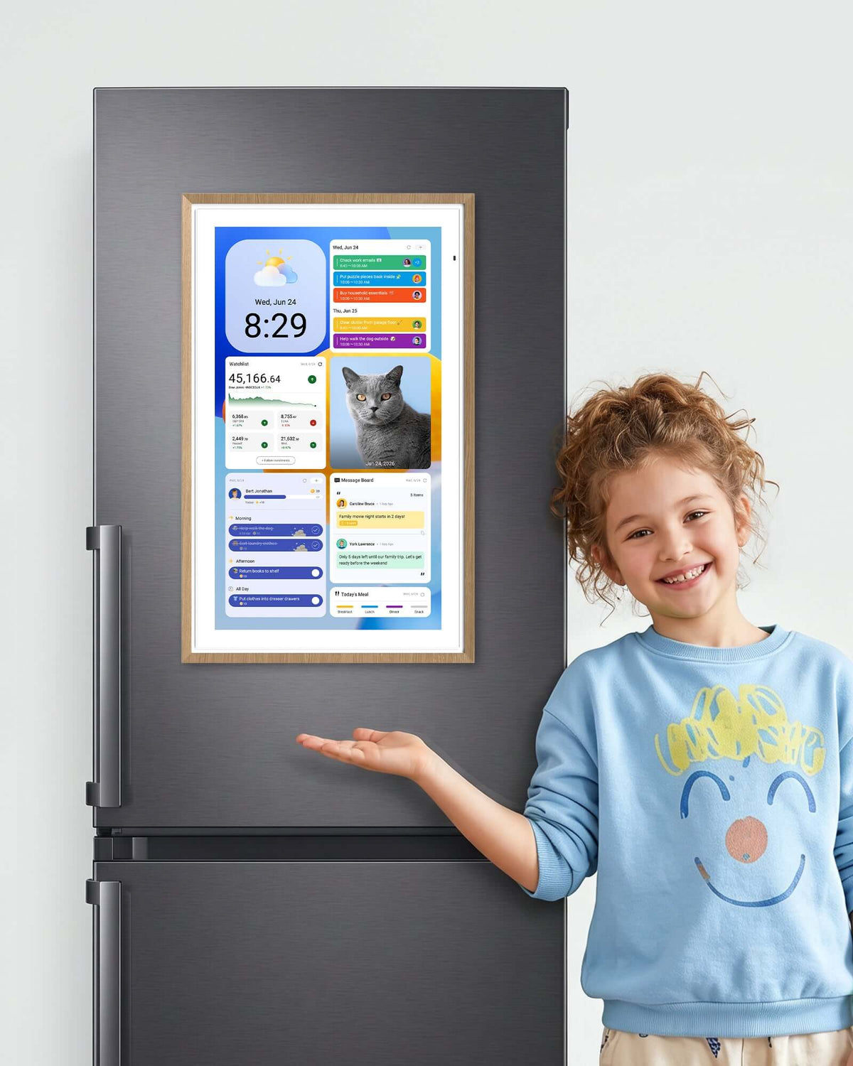 Young girl presenting a digital calendar mounted on a refrigerator using the Magnetic Mount.