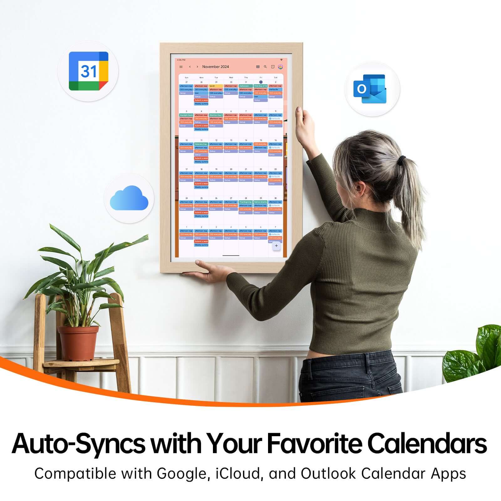 Woman hangs smart digital calendar showing November schedule, syncing with Google, iCloud, and Outlook icons.