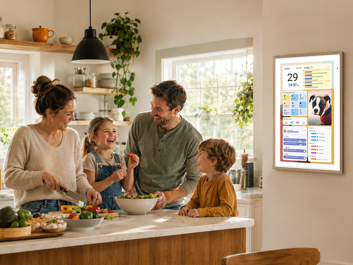Family of four preparing dinner with a wall-mounted Apolosign digital family calendar displaying schedules and meal plans.