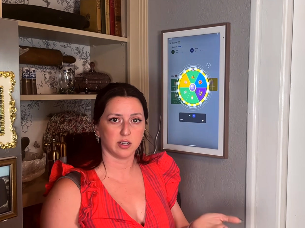 A woman stands in front of a Digital Calendar displaying a reward wheel interface.